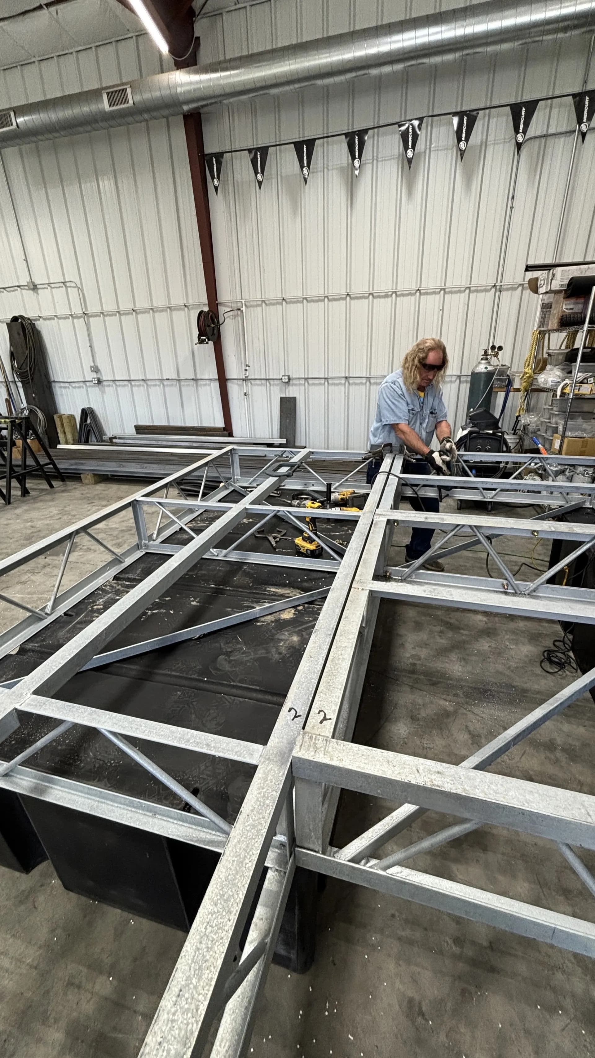 Welding a steel floating dock frame in the Big Thunder fabrication shop